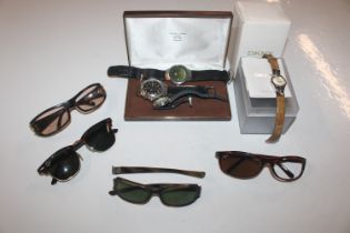 A collection of wrist watches and sun glasses