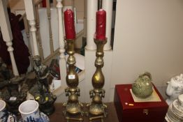 A large pair of ornate brass candlesticks
