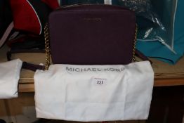 A Michael Kors purple small chain handled bag