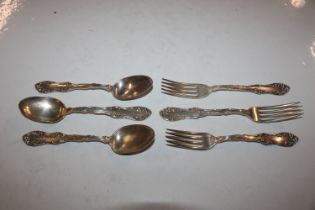 Three white metal forks marked Sterling, and three