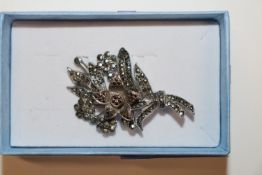 An unusual silver and marcasite brooch with centra