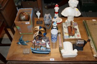 A plaster bust; a model lighthouse; model boats; a