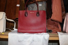 A Michael Kors wine coloured bag and purse