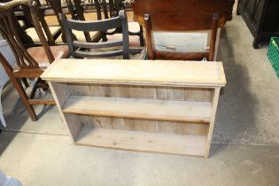 A stripped pine hanging shelf