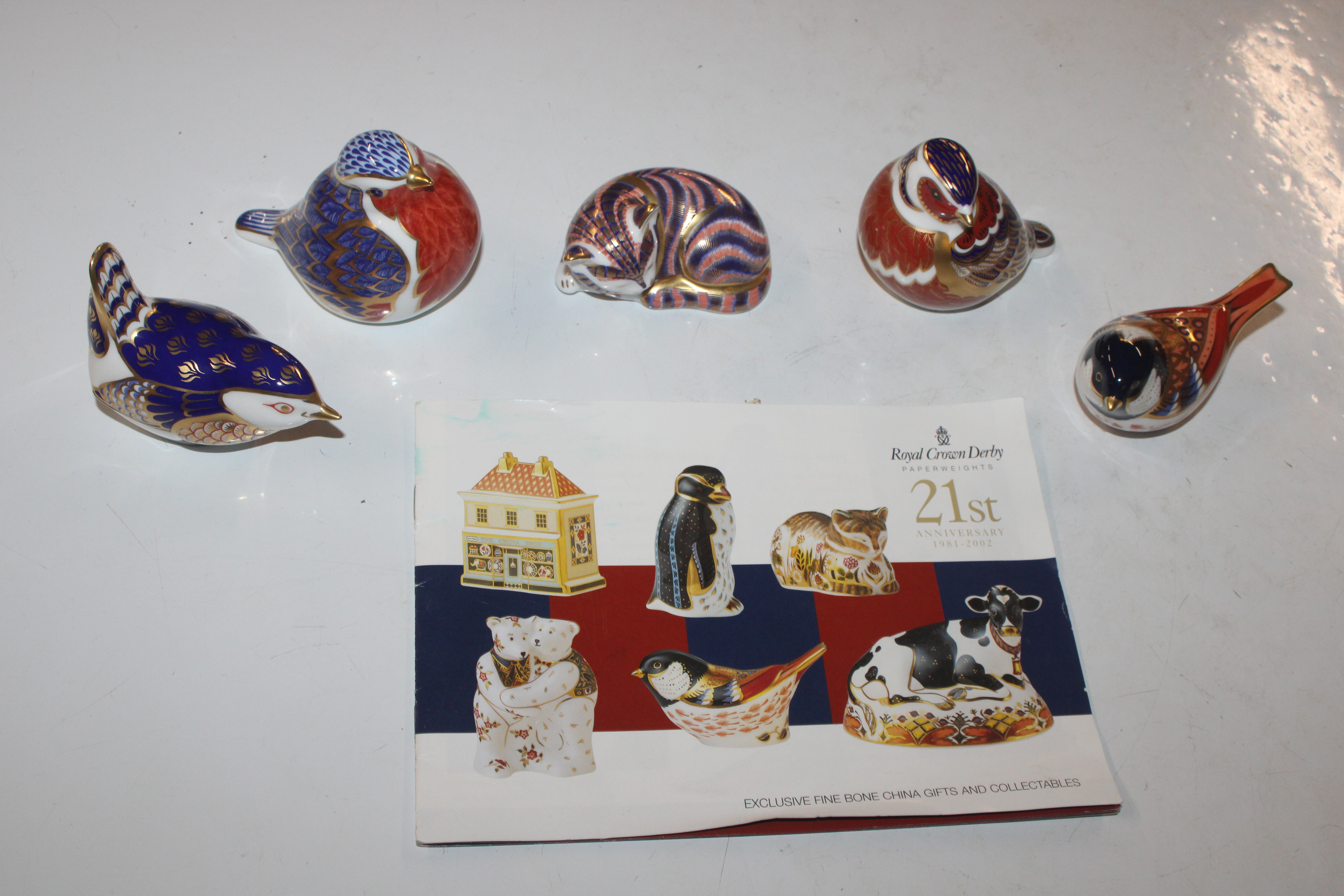 Five Royal Crown Derby paper weights, four in the