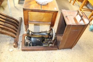 A Singer hand sewing machine in fitted case