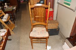 An elm stick back hall chair with upholstered seat