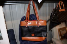 A Dooney Bourke shoulder bag with outer protective