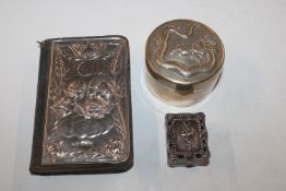 A Chinese white metal circular box and cover with