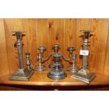 A pair of plated Corinthian column candlesticks; a