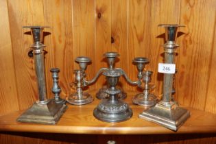 A pair of plated Corinthian column candlesticks; a