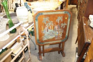 An Oriental decorated folding table