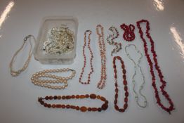 Two boxes containing coral and pearl necklaces