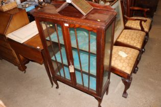 An oak and glazed display cabinet, the interior fi