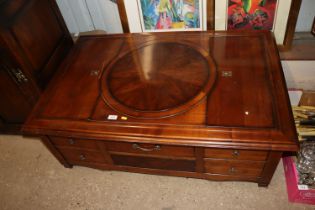 An unusual mahogany coffee table with lifting comp