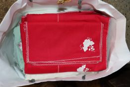 A bag of embroidered table cloths etc.