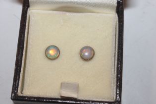 A pair of yellow metal opal set stud ear-rings