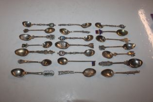 A collection of silver and white metal souvenir sp