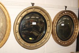A gilt convex wall mirror with ball decoration