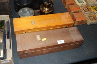 Two cases containing Magic Lantern slides depictin