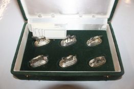 A cased set of six continental white metal name pl