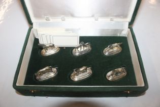 A cased set of six continental white metal name pl