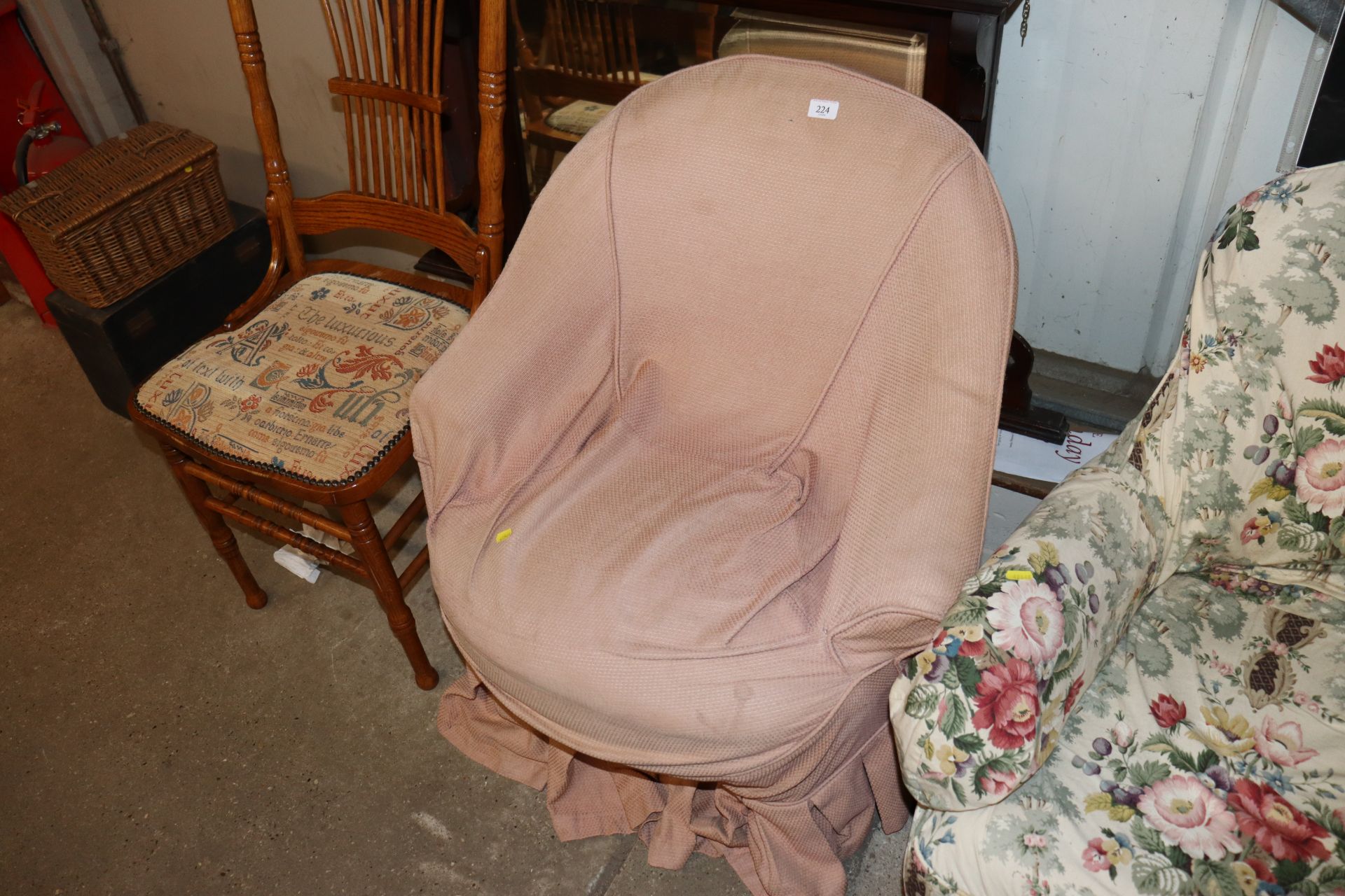 An early 20th Century tub shaped easy chair on cab