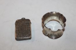 A silver vesta case and a silver napkin ring