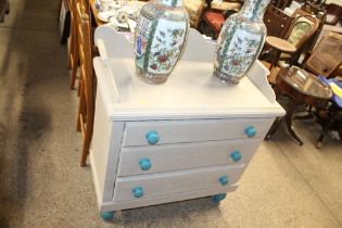 A painted pine chest fitted three drawers