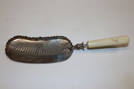 A late Victorian silver crumb scoop with bone hand