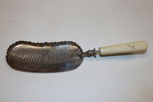 A late Victorian silver crumb scoop with bone hand