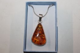 A large Hallmarked Sterling silver and amber penda