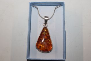 A large Hallmarked Sterling silver and amber penda