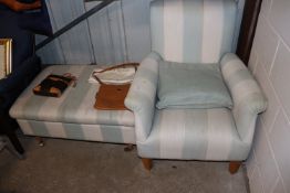 An upholstered armchair and matching stool