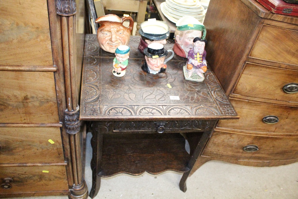 A 20th Century carved oak side table, with fitted