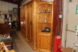 A stripped pine freestanding corner cupboard