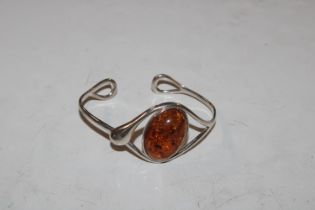 A large Sterling silver and amber torque bangle, a