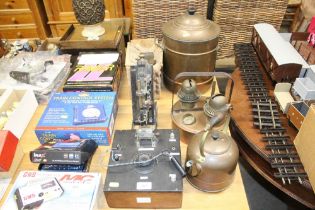A crystal radio and a blow lamp; a copper urn, cop