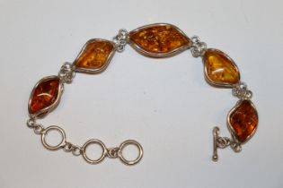 A large Sterling silver and amber bracelet, approx