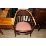 An early 20th Century tub shaped low armchair