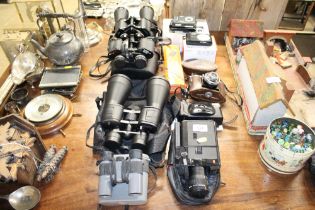 A quantity of various cameras and binoculars