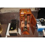 A mahogany cased microscope and a box of miscellan
