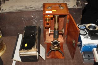 A mahogany cased microscope and a box of miscellan