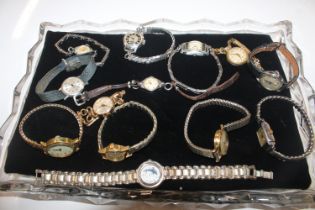 A glass tray and contents of various ladies wrist