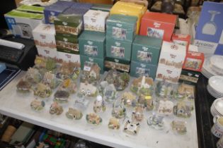 A large collection of Lilliput Lane cottages with