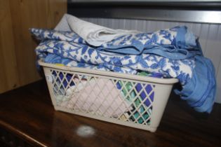 A plastic basket and contents of various textiles