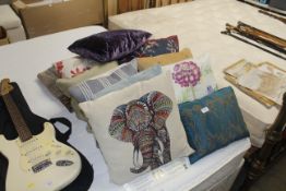 A collection of various decorative loose cushions