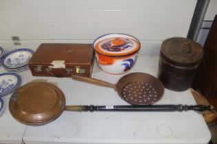 An antique copper warming pan with turned wooden handle, an iron skillet, a tin hat box, a vintage