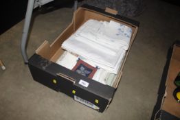 A box of miscellaneous linen and napkins