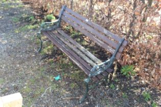 A wooden and metal two seater garden bench